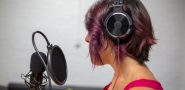 woman speaking into a microphone with pop filter.